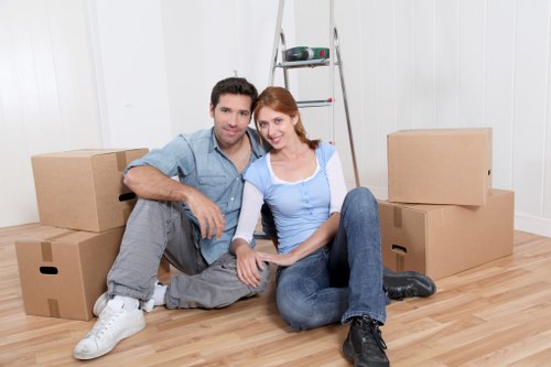 Moving team wearing PPE while carrying furniture safely